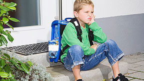 Boy sitting on step