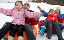 A family sledding together.